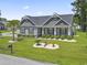 Charming home featuring manicured lawn, stone accents, and a well-designed landscape at 901 Queensferry Ct., Conway, SC 29526