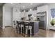 Kitchen island featuring granite countertops, barstool seating, modern stainless steel refrigerator, and pendant lighting at 901 Queensferry Ct., Conway, SC 29526