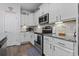 Kitchen featuring white cabinets, granite countertops, stainless steel appliances, and under cabinet lighting at 901 Queensferry Ct., Conway, SC 29526