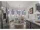 Stainless steel refrigerator and view into dining area with hardwood floors at 901 Queensferry Ct., Conway, SC 29526