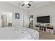 Bright main bedroom with a large TV and open doorway to the seating area and bathroom at 901 Queensferry Ct., Conway, SC 29526