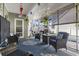 Charming sunroom with wicker furniture, nautical rug, and decorative plants at 901 Queensferry Ct., Conway, SC 29526