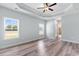 Main bedroom with tray ceiling, ceiling fan and wood-look flooring at Tbd Hodges Rd., Conway, SC 29527