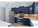 Modern kitchen with stainless steel appliances and navy blue cabinets at Tbd Hodges Rd., Conway, SC 29527