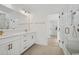 Luxurious bathroom with double vanity, modern fixtures, and glass-enclosed shower, showcasing elegant design and functionality at 1816 Tryon Dr, Myrtle Beach, SC 29588
