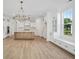 Open-concept kitchen featuring a spacious island, white cabinetry, stainless steel appliances, and ample natural light at 1816 Tryon Dr, Myrtle Beach, SC 29588