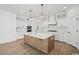 Modern kitchen island with white countertop and wooden base, complemented by white cabinets and stainless steel appliances at 1816 Tryon Dr, Myrtle Beach, SC 29588