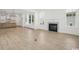Open concept living space with fireplace, large windows, and a modern kitchen in the background at 1816 Tryon Dr, Myrtle Beach, SC 29588