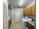 Bright laundry room with washer, dryer, and cabinets at 1818 Topsail Ln., North Myrtle Beach, SC 29582