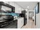 Modern kitchen with black appliances and blue tile backsplash at 2004 N Ocean Blvd. # 1472, Myrtle Beach, SC 29572