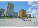 Expansive view of the beach with condo buildings with people enjoying the day at 2504 North Ocean Blvd. # 436, Myrtle Beach, SC 29577