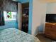 Bedroom with a beachy vibe includes a large window, dresser, and a closet for ample storage at 2504 North Ocean Blvd. # 436, Myrtle Beach, SC 29577