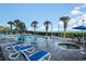 Beautiful pool area with lounge chairs and lush landscaping with ocean view at 2504 North Ocean Blvd. # 436, Myrtle Beach, SC 29577