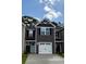 Two-story townhome with a one-car garage, neutral siding and a covered entry at 261 Christiana Ln. # D, Myrtle Beach, SC 29579