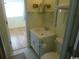 Simple bathroom with white vanity, toilet, and a view of another room at 2710 Ocean Blvd. S # 406, Myrtle Beach, SC 29577