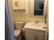 Clean bathroom with white vanity, toilet, and a medicine cabinet at 2710 Ocean Blvd. S # 406, Myrtle Beach, SC 29577