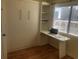 Bedroom with a Murphy bed, desk, and built-in shelving at 2710 Ocean Blvd. S # 406, Myrtle Beach, SC 29577