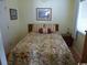 Cozy bedroom with floral bedding, wooden furniture, and light walls at 2710 Ocean Blvd. S # 406, Myrtle Beach, SC 29577