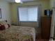 Bright bedroom with floral bedding, wooden furniture, and a wall-mounted TV at 2710 Ocean Blvd. S # 406, Myrtle Beach, SC 29577