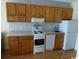 Kitchen with granite countertops, wooden cabinets, and appliances at 2710 Ocean Blvd. S # 406, Myrtle Beach, SC 29577