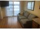 Living room with balcony access and a comfortable sofa at 2710 Ocean Blvd. S # 406, Myrtle Beach, SC 29577