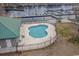Aerial view of a community pool area with a unique clover shape, lounge chairs, and gazebo near the river at 301 Crossing Ct., Myrtle Beach, SC 29588