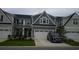 Two-story townhome with gray siding, two-car garage, and landscaping at 325 Golan Circle # 12B, Myrtle Beach, SC 29579