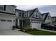 Two-story townhome with gray siding, two-car garage, and landscaping at 325 Golan Circle # 12B, Myrtle Beach, SC 29579