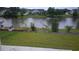 Peaceful backyard view of a tranquil lake with lush greenery at 325 Golan Circle # 12B, Myrtle Beach, SC 29579