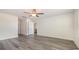 Open bedroom features modern gray flooring, ceiling fan and access to the kitchen at 3450 Ashridge Way, Conway, SC 29526