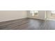 Bright living room showcasing stylish gray floors and natural light from large windows at 3450 Ashridge Way, Conway, SC 29526