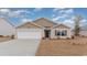 Tan house with white garage door and landscaping at 3457 Ashridge Way, Conway, SC 29526