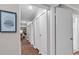 Hallway featuring wood-look flooring, white doors, art, and access to the main living area at 415 Ocean Creek Dr. # 2139, Myrtle Beach, SC 29572