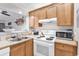Well-maintained kitchen featuring bright lighting, neutral countertops, and white appliances at 415 Ocean Creek Dr. # 2139, Myrtle Beach, SC 29572