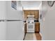 Kitchen featuring white appliances, wood cabinets, and a view into the adjacent dining area at 415 Ocean Creek Dr. # 2139, Myrtle Beach, SC 29572