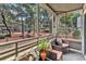 Outdoor screened patio with wicker furniture and lush courtyard views at 415 Ocean Creek Dr. # 2139, Myrtle Beach, SC 29572