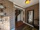 Inviting entryway with brick walls, hardwood floors, and a mirror at 462 Mohican Dr., Georgetown, SC 29440