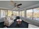 Sunroom with a river view, comfortable seating, and a fireplace at 462 Mohican Dr., Georgetown, SC 29440