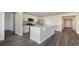 Open kitchen with island, stainless steel appliances, and luxury vinyl flooring at 5800 Ellisridge Ct, Conway, SC 29526