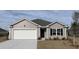Charming single-story home featuring neutral siding, a two-car garage, and well-maintained landscaping at 5805 Ellisridge Ct, Conway, SC 29526