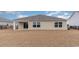 Backyard of a home with a large dry lawn, black fencing and a covered patio at 5810 Ellisridge Ct, Conway, SC 29526