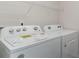 This is a laundry room with a white Whirlpool washer and dryer with a wire shelf above at 5810 Ellisridge Ct, Conway, SC 29526