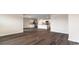 Open-concept living space showcasing modern flooring, a kitchen with an island, and neutral wall colors at 5810 Ellisridge Ct, Conway, SC 29526