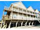 Three-story beach house with multiple balconies and parking underneath at 613 Sea Mountain Hwy. # 128, North Myrtle Beach, SC 29582