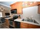 Kitchen with stainless steel appliances and wood cabinets at 613 Sea Mountain Hwy. # 128, North Myrtle Beach, SC 29582