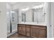 Bathroom featuring double sink vanity with wood cabinets, chrome fixtures and glass shower at 626 Lorenzo Dr. # 626, North Myrtle Beach, SC 29582