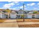 Charming townhome featuring a gray exterior, attached garage, and well-maintained landscaping under a bright blue sky at 626 Lorenzo Dr. # 626, North Myrtle Beach, SC 29582