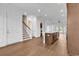 Open-concept living area with white walls, wood floors, and a staircase leading to the upper level at 626 Lorenzo Dr. # 626, North Myrtle Beach, SC 29582