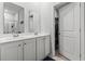 Bright bathroom features a double sink vanity with white cabinetry and a walk-in closet at 775 Oyster Bluff Dr., Myrtle Beach, SC 29588