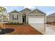 Charming single-story home with a two-car garage, manicured lawn, and neutral green siding at 775 Oyster Bluff Dr., Myrtle Beach, SC 29588